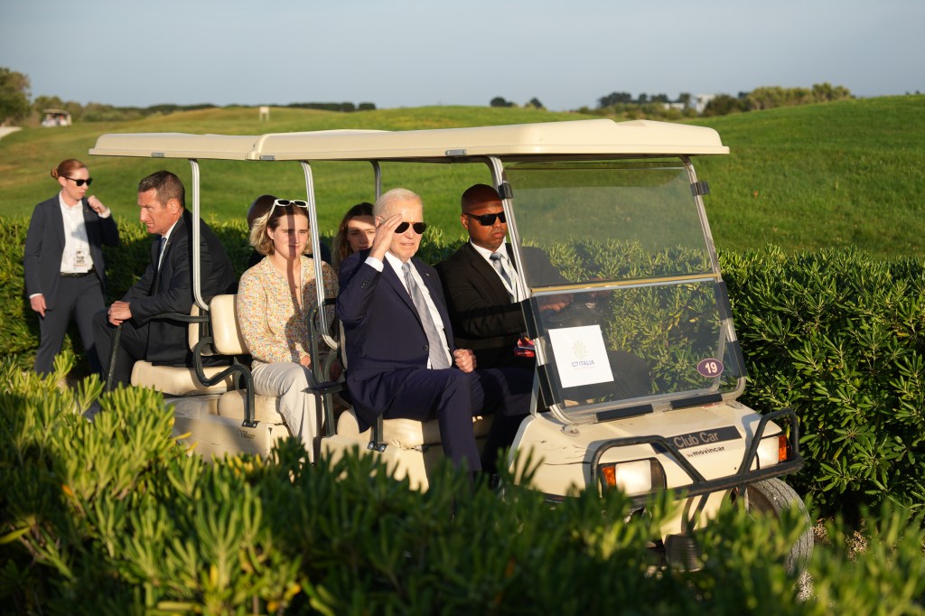 Biden riding a cart with his granddaughter Maisy at the G7 summit.
