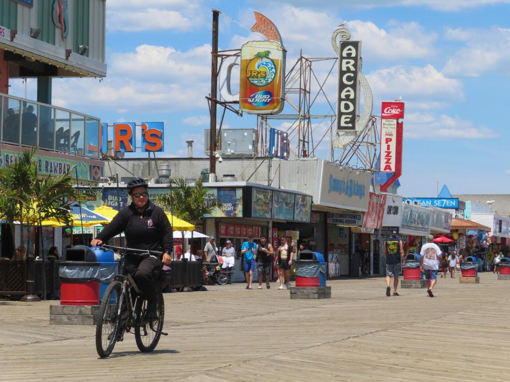 Police officer patrolling a boardwalk on a bicycle in Seaside Heights, New Jersey