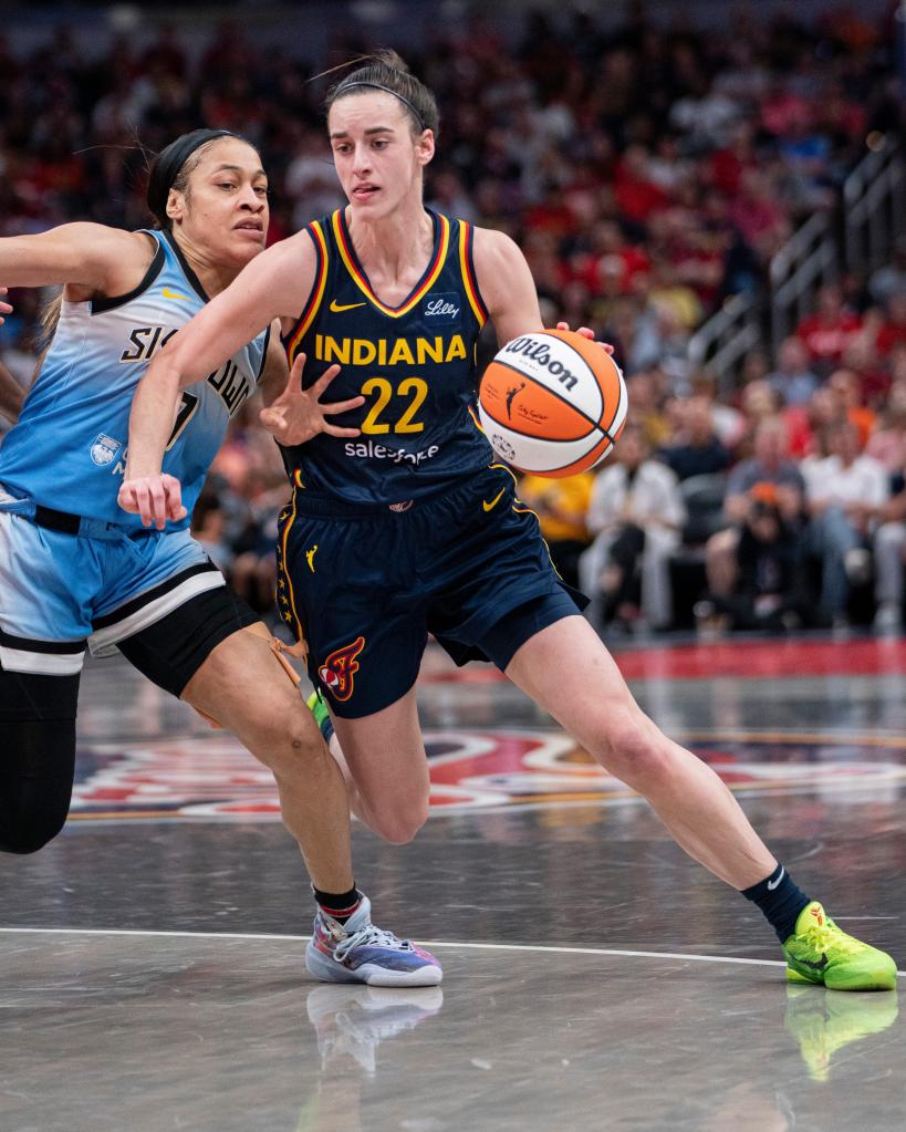 Indiana Fever guard Caitlin Clark (22) dribbles around Chicago Sky guard Chennedy Carter (7) during the game at Gainbridge Fieldhouse in Indianapolis on Sunday June 16, 2024. 