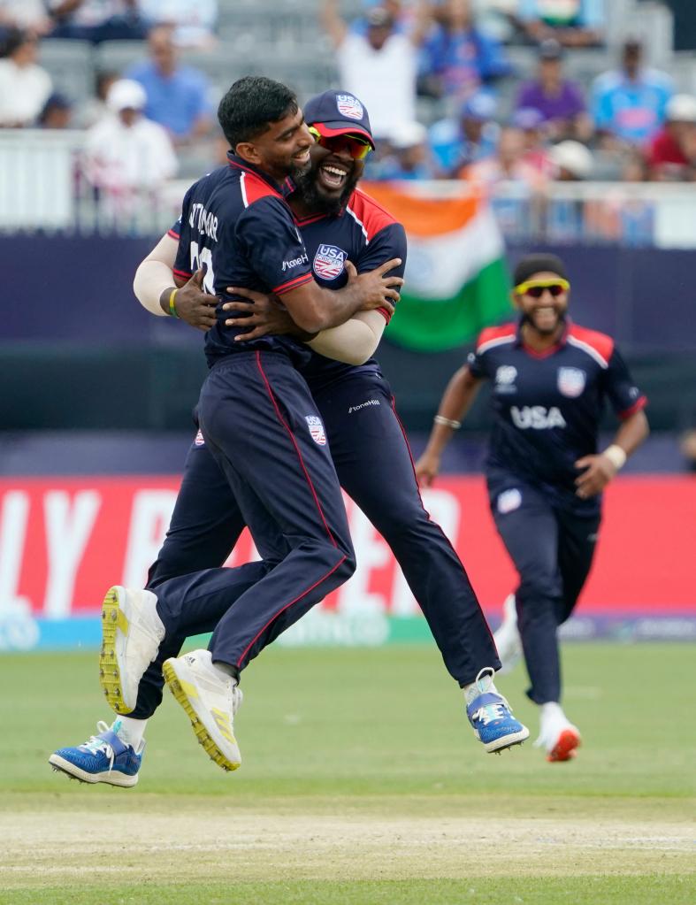 USA's Saurabh Netralvakar (L) celebrates with teammate Steven Taylor after dismissing India's Virat Kohli during the ICC men's Twenty20 World Cup 2024 group A cricket match between the USA and India at Nassau County International Cricket Stadium in East Meadow, New York on June 12, 2024