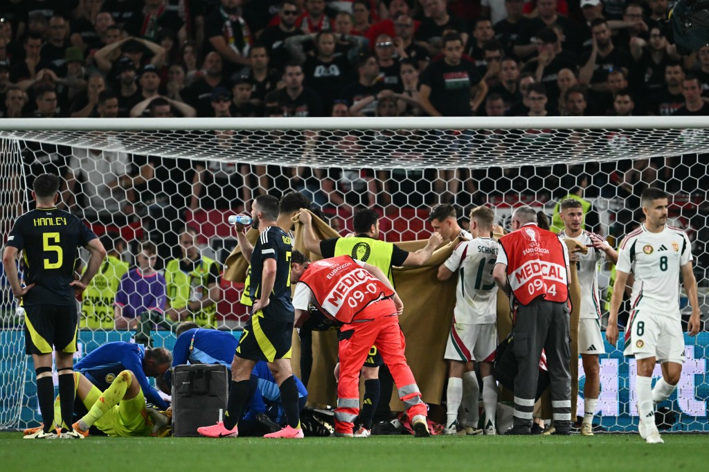 Hungary's forward Barnabas Varga receiving medical treatment on field during UEFA Euro 2024 Group A football match between Scotland and Hungary