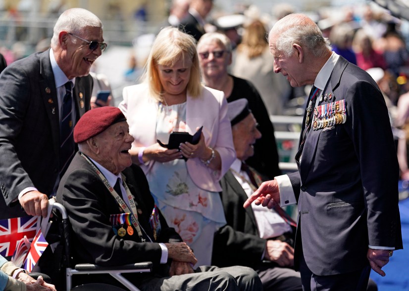King Charles III (R) greets D-Day veteran Len Trewin, 98.
