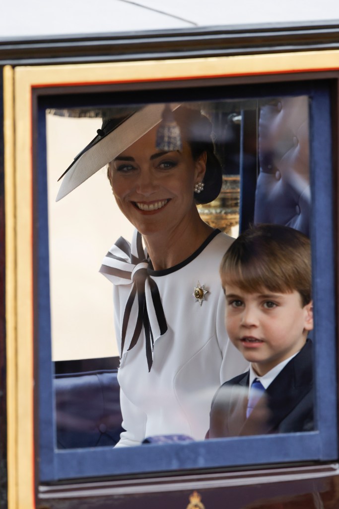 Little Louis  sat next to his mom in the carriage. 