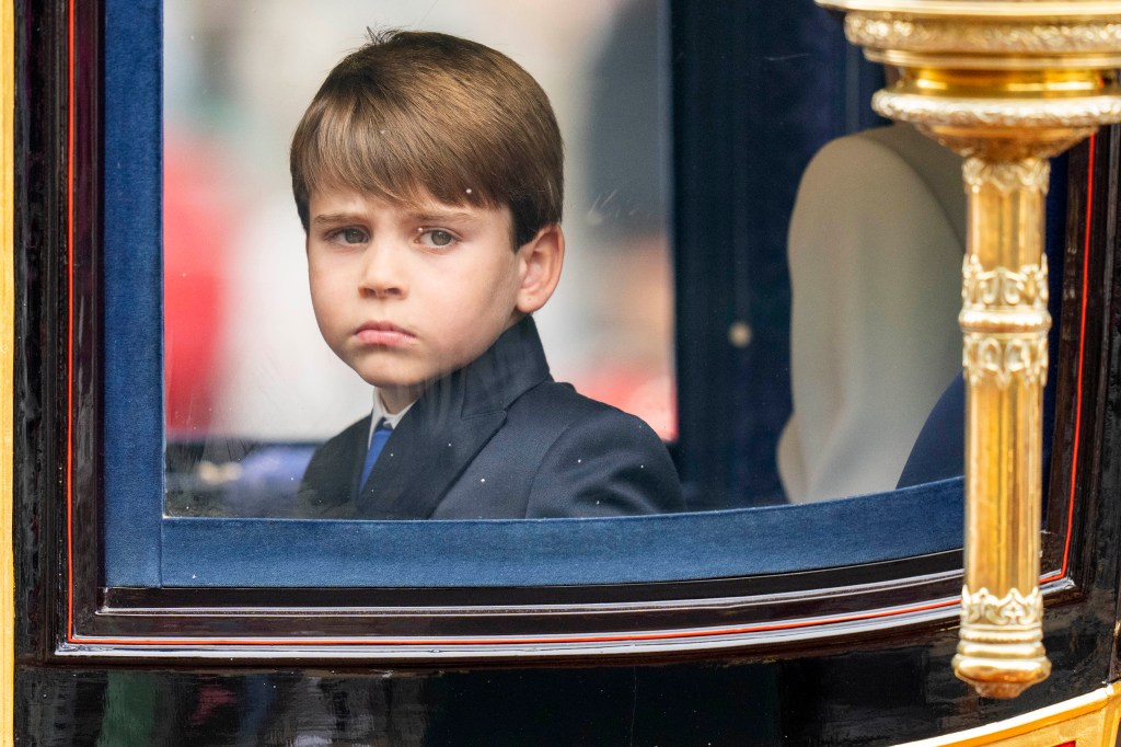 The little prince looked dapper in a black blazer and blue tie. 