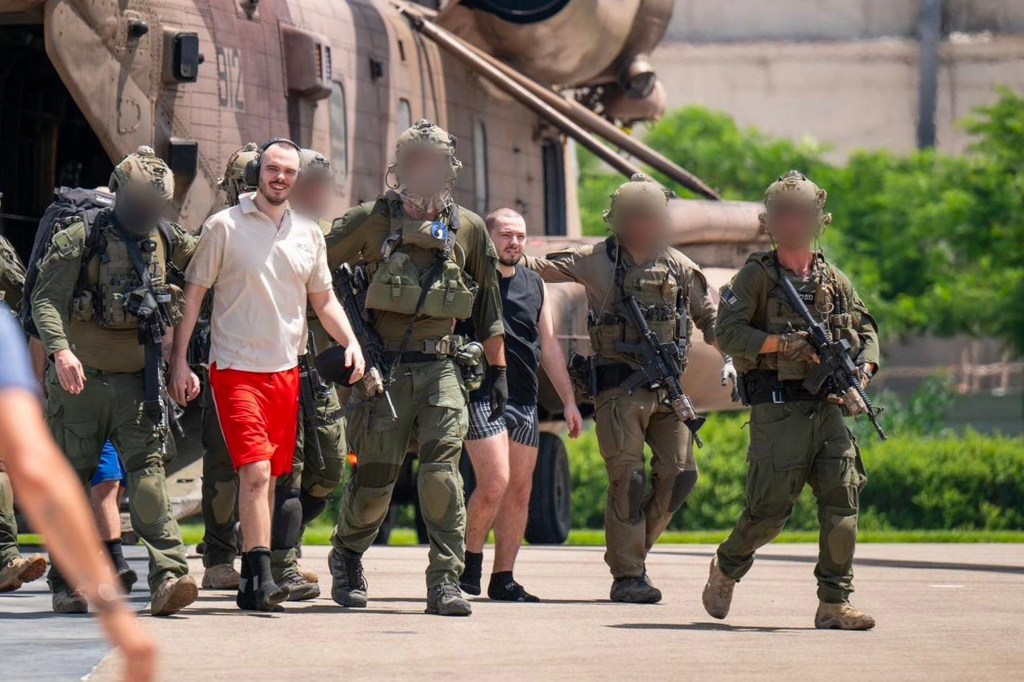 Andrey Kozlov and Almog Meir Jan, recently rescued hostages, walking by a helicopter after returning to Israel from Gaza