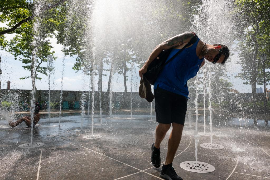 man cooling off in fountain