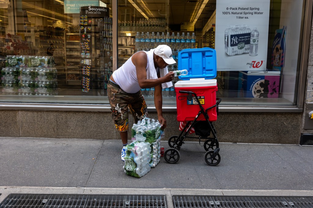 A man fills a cooler with water in lower Manhattan during the city's first heatwave of the year. 