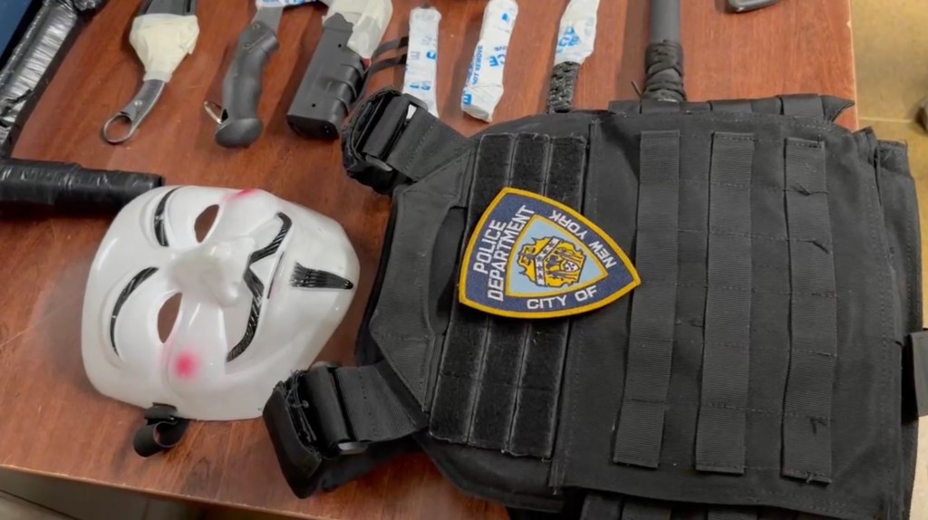 A mask and NYPD vest confiscated from the suspect.