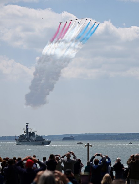 British Royal Air Force's aerobatic team, the "Red Arrows" perform a flypast above HMS St Albans, a Type 23 Frigate, during the UK's national commemorative event for the 80th anniversary of D-Day in Southsea Commons on June 5, 2024 in Portsmouth, England.