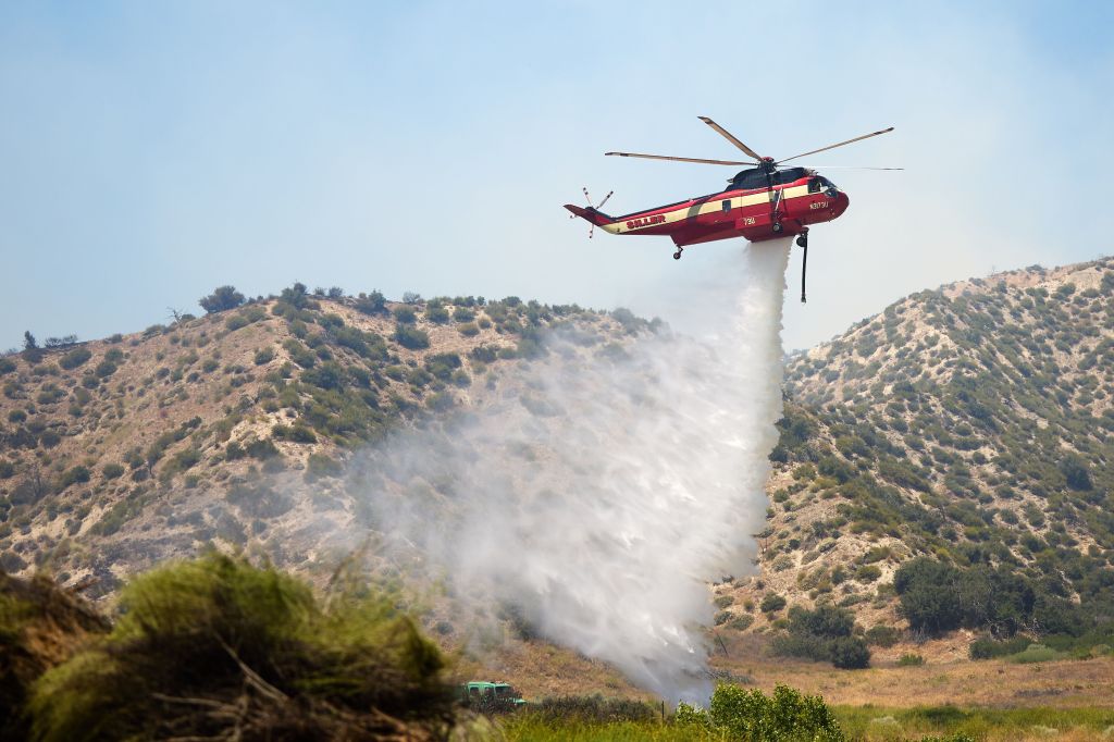 Helicopter dropping water on the Post Fire in Lebec, California, June 16, 2024