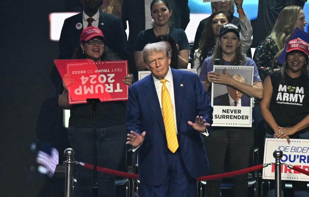 Former US President and 2024 Republican presidential candidate Donald Trump gestures as he arrives for a town hall event at Dream City Church in Phoenix, Arizona, on June 6, 2024.