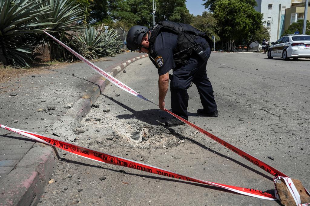 An Israeli officer tapes an area where a Hezbollah rocket was shot down in Kiryat Shmona on Wednesday.