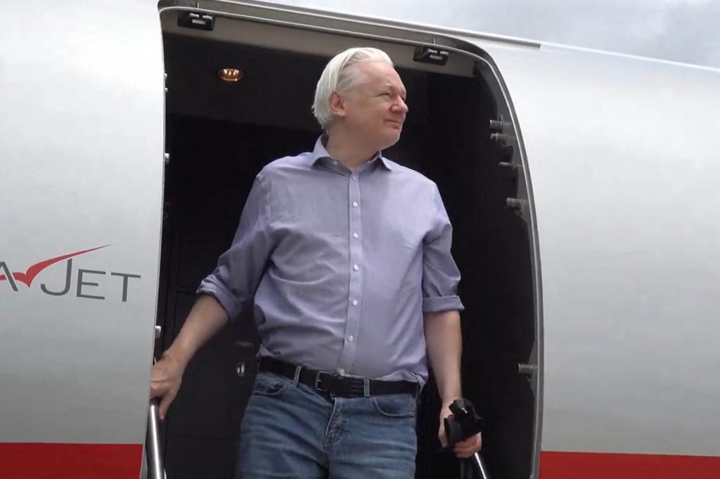 Julian Assange steps off the VistaJet plane in Saipan on Tuesday. He is due in federal court on Wednesday