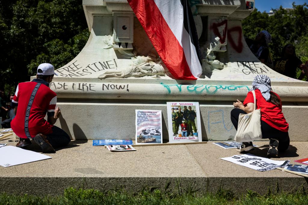 Pro-Palestinian activists write graffiti messages on the Rochambeau Statue in Lafayette Park next to the White House during a demonstration protesting the war in Gaza on June 8, 2024 in Washington, DC. 