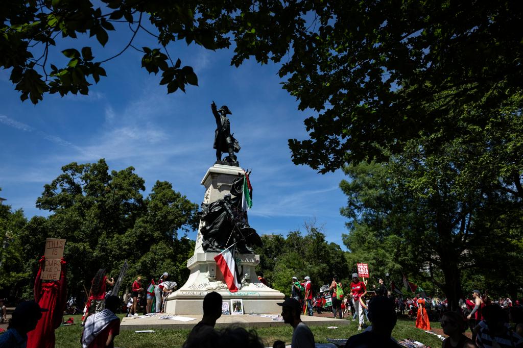 Pro-Palestinian activists leave Palestinian flags and graffiti on the Rochambeau Statue in Lafayette Park next to the White House during a demonstration protesting the war in Gaza on June 8, 2024 in Washington, DC.