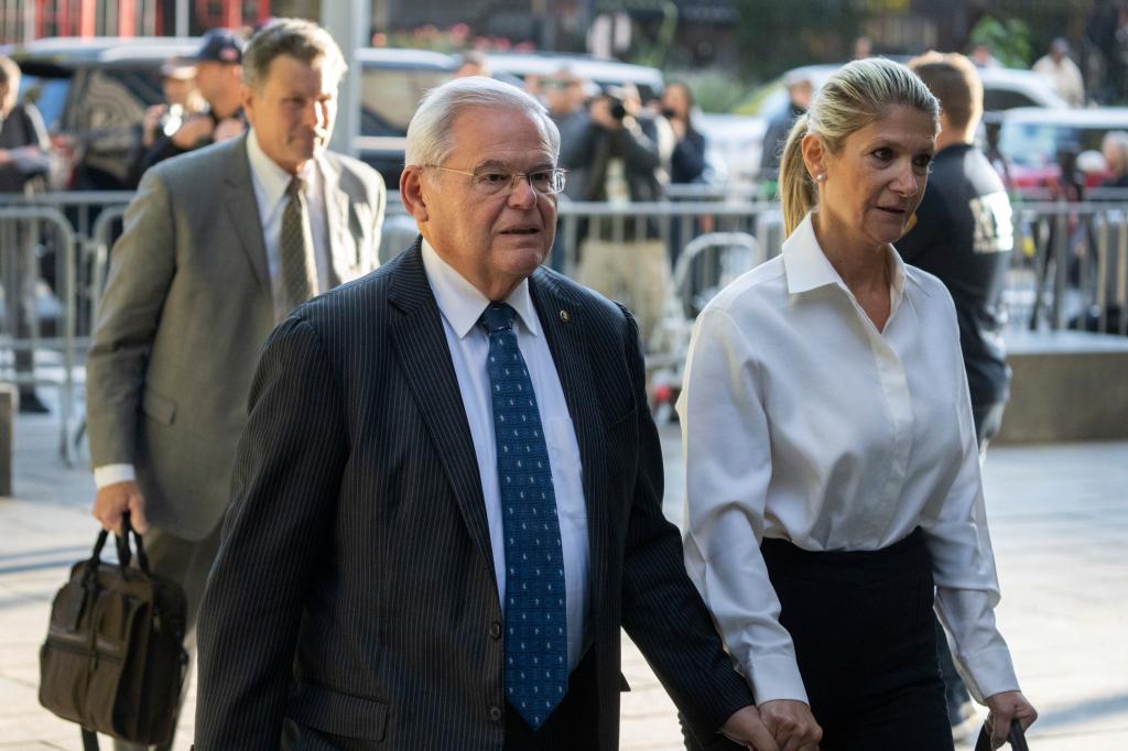 Robert Menendez and Nadine Arslanian arrive at federal court in Manhattan holding hands.