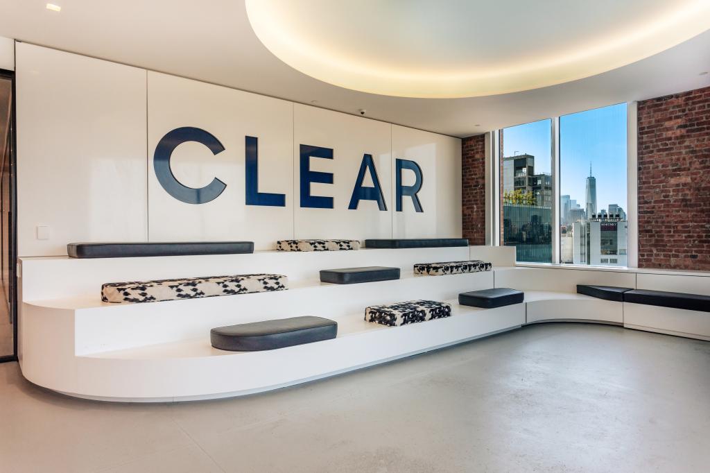 A room inside CLEAR headquarters in Chelsea, Manhattan, featuring a large white wall and black and white benches, photographed on May 22, 2024.