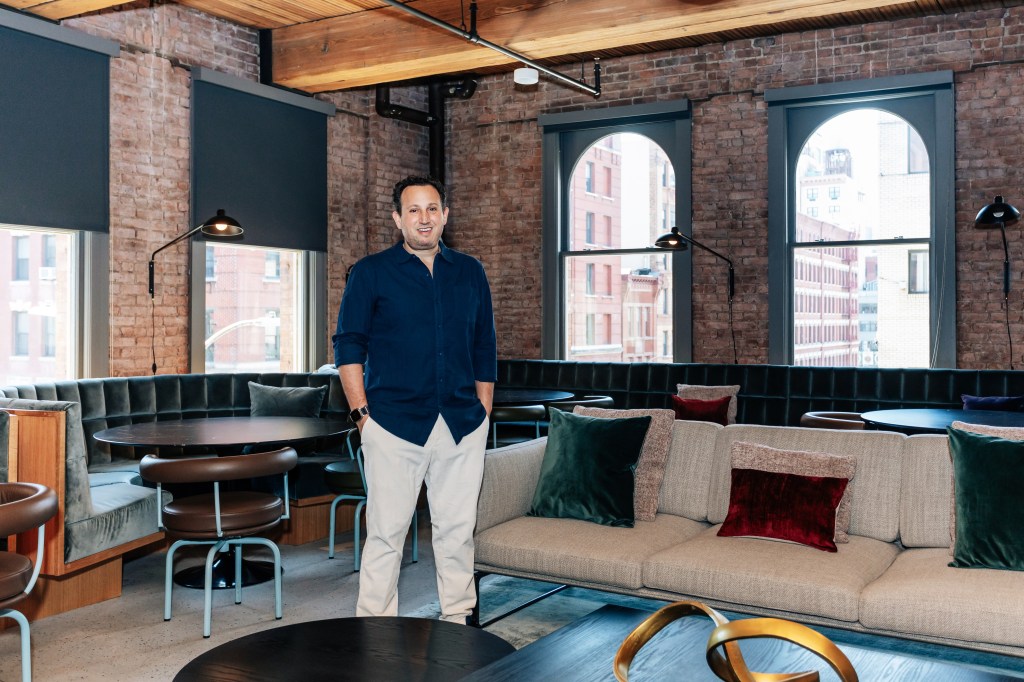 David Ulevitch standing in his company office, Andreessen Horowitz, furnished with a couch and tables, in Soho, Manhattan on June 13, 2024.