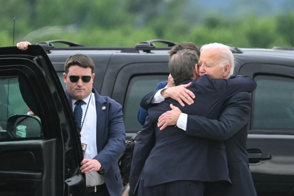 US President Joe Biden hugs his son Hunter Biden upon arrival at Delaware Air National Guard Base in New Castle, Delaware.