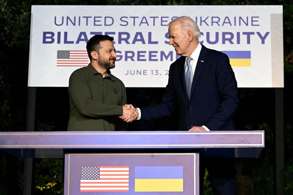  US President Joe Biden and Ukrainian President Volodymyr Zelensky (L) shake hands after signing a bilateral security agreement during a press conference at the Masseria San Domenico on the sidelines of the G7 Summit hosted by Italy.