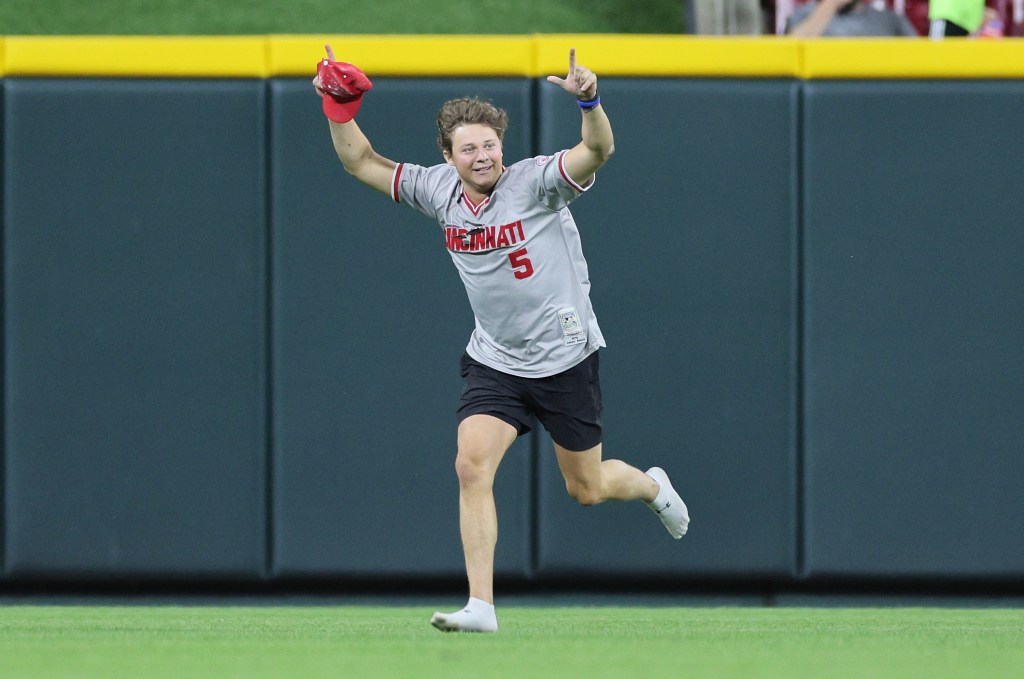 The fan ran onto the field during the Reds game.