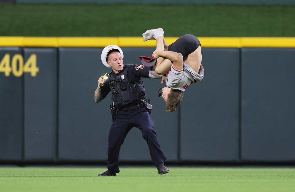 An unidentified fan does a flip on the field before the ninth inning of the Cincinnati Reds against Cleveland Guardians at Great American Ball Park.