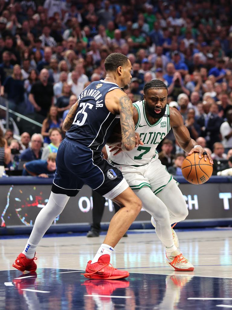 Jaylen Brown of the Boston Celtics dribbling the ball while being guarded by P.J. Washington of the Dallas Mavericks during the 2024 NBA Finals