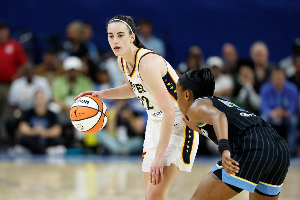 Fever guard Caitlin Clark (22) brings the ball up court against the Chicago Sky during the first half of a basketball game at Wintrust Arena on June 23, 2024.