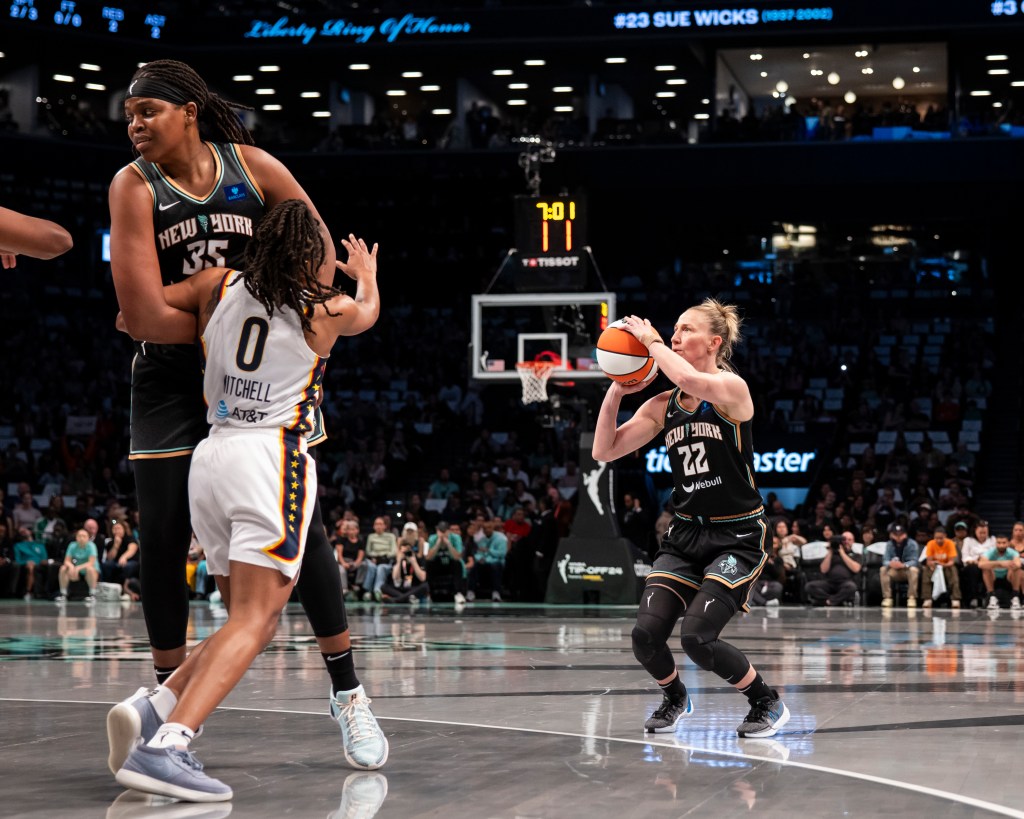 Courtney Vandersloot #22 of the New York Liberty makes basket against the Indiana Fever during their home opener at Barclays Center.