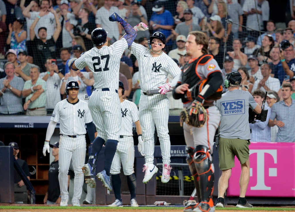 Giancarlo Stanton #27 of the New York Yankees is greeted by Alex Verdugo #24 of the New York Yankees after Stanton scores on his three run homer during the 7th inning.