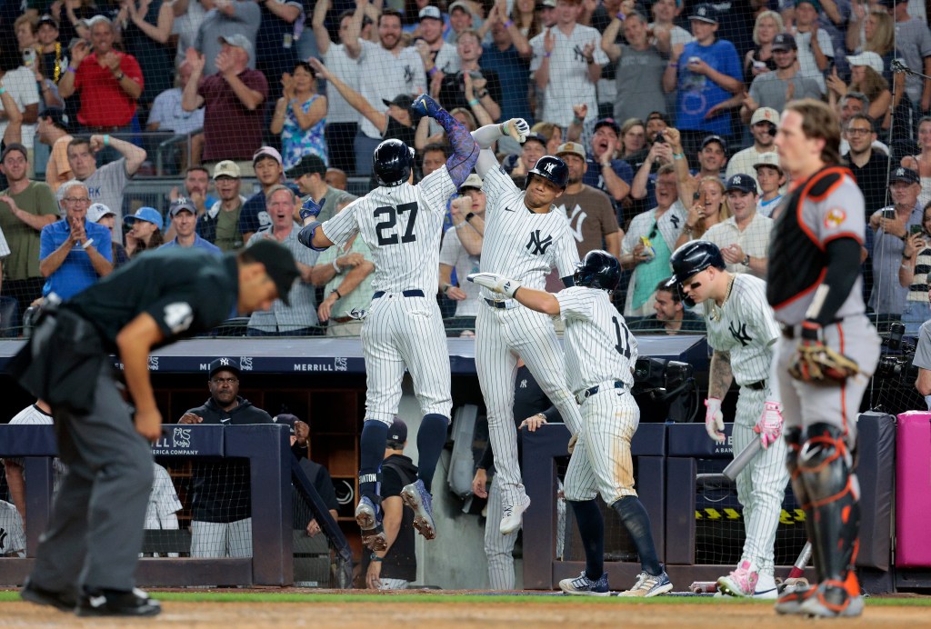Yankees is greeted by Juan Soto #22 of the New York Yankees after Stanton scores on his three run homer during the 7th inning.