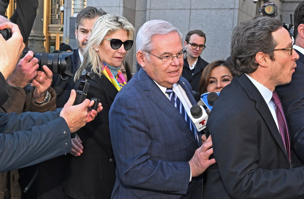 Nadine Arslanian and Sen. Robert Menendez walking into court, surrounded by photographers and reporters with microphones