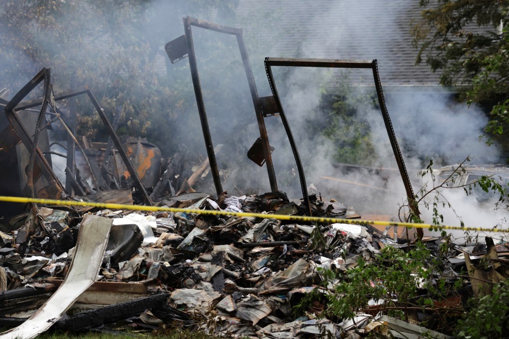 Smoke still emanated from the destroyed house on Wednesday. 