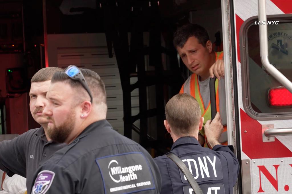 A police officer and firefighter at the scene of a tragic accident involving a pedestrian and a DOT truck in Bay Ridge, Brooklyn.