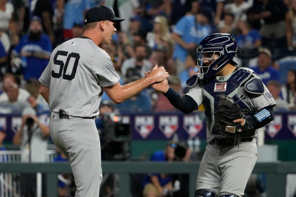 Michael Tonkin #50 of the New York Yankees and Jose Trevino #39 of the New York Yankees celebrate a 4-2 win over the Kansas City Royals.