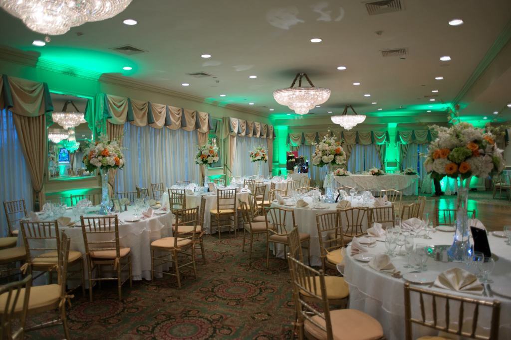 Interior of Il Villaggio, with chairs set up around cloth-covered tables set for a meal