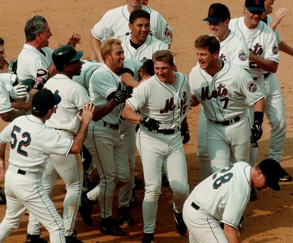 Matt franco is mobbed by players and manager Bobby Valentine, after getting bases loaded single to win game in 9th. inning