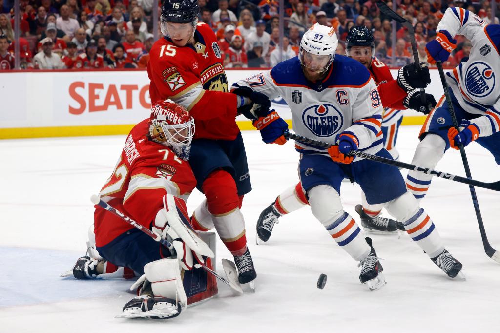 Panthers makes a save while Anton Lundell #15 of the Florida Panthers defends Connor McDavid #97 of the Edmonton Oilersduring the third period of Game Seven of the 2024 Stanley Cup Final.