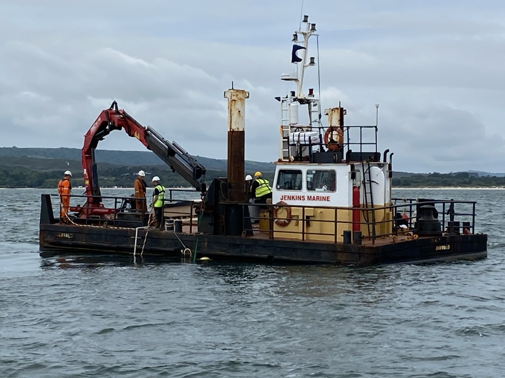 Maritime archaeologists from Bournemouth University recovering two medieval graves slabs carved from Purbeck marble from Studland Bay