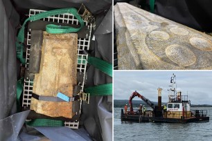 Maritime archaeologists from Bournemouth University retrieving two medieval grave slabs made from Purbeck marble from the bottom of Studland Bay