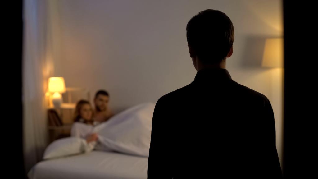 man catches couple in bed