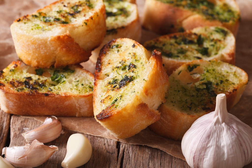 Garlic bread with herbs on top, symbolizing unhealthy white bread starters