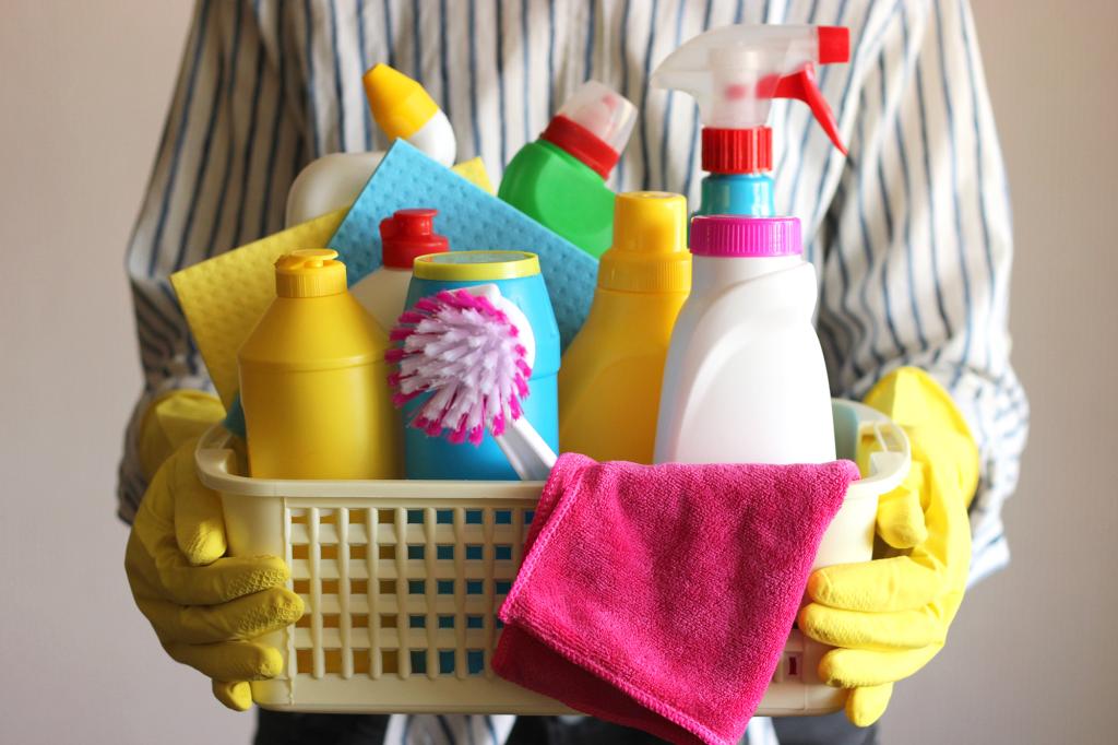 person holding cleaning supplies