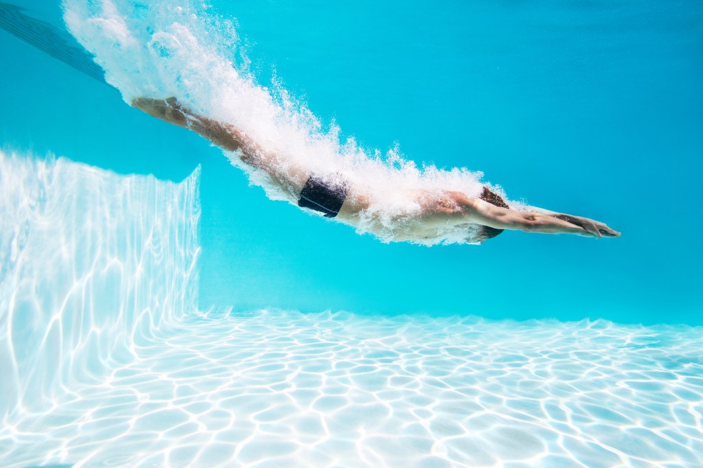 Man diving into swimming pool