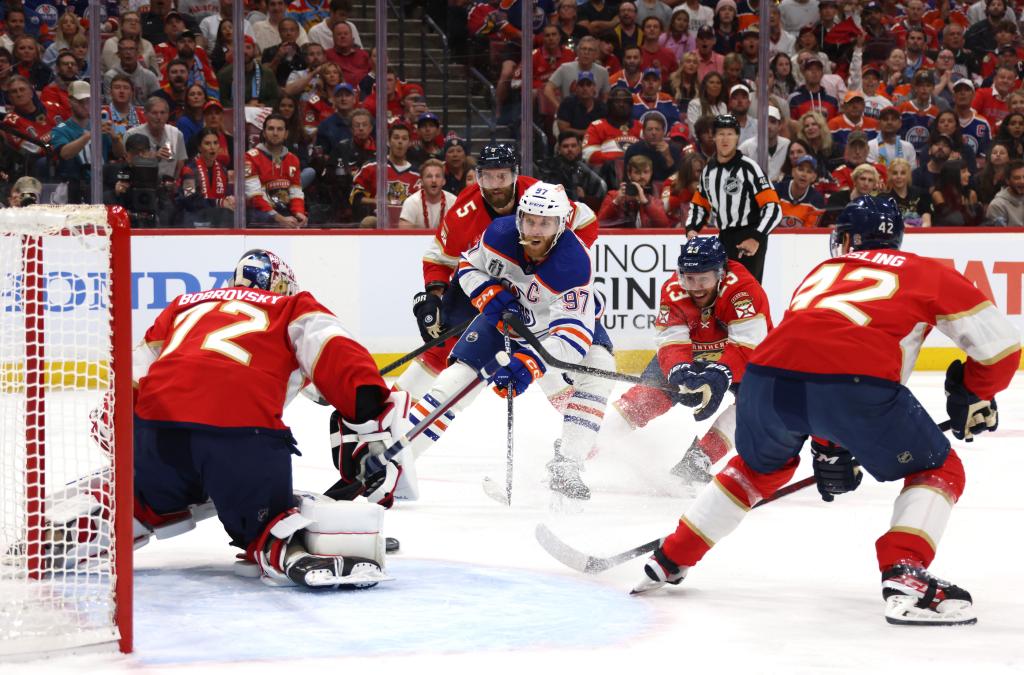 Connor McDavid #97 of the Edmonton Oilers attempts a shot on goaltender Sergei Bobrovsky #72 of the Florida Panthers while defended by Aaron Ekblad #5, Carter Verhaeghe #23 and Gustav Forsling #42 during first period of Game 1 of the 2024 Stanley Cup Final between the Edmonton Oilers and the Florida Panthers at Amerant Bank Arena on June 8, 2024 in Sunrise, Florida.   