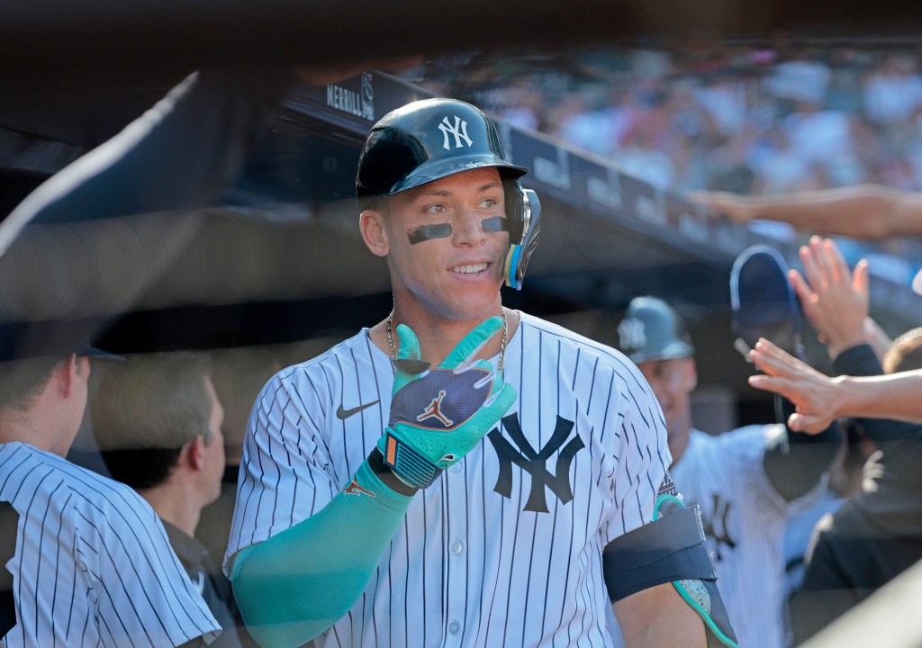 New York Yankees at Yankee Stadium: Aaron Judge #99 of the New York Yankees is greeted by his teammates in the dugout after he scores on his two-run homer driving home Juan Soto #22 of the New York Yankees during the third inning.