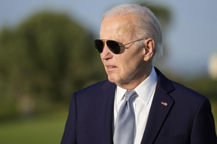 President Joe Biden answers a question as he watches a skydiving demonstration, at the G7 summit, June 13, 2024.