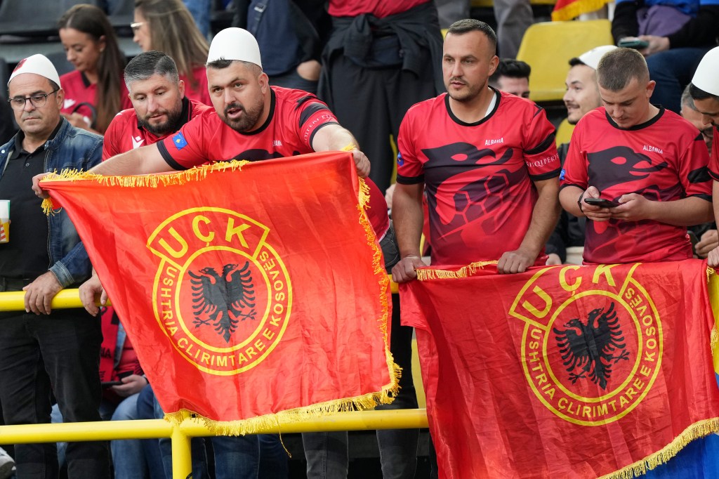 Albanian supporters holding flags of the Kosovo Liberation Army during a game against Italy at Euro 2024 on June 15, 2024.
