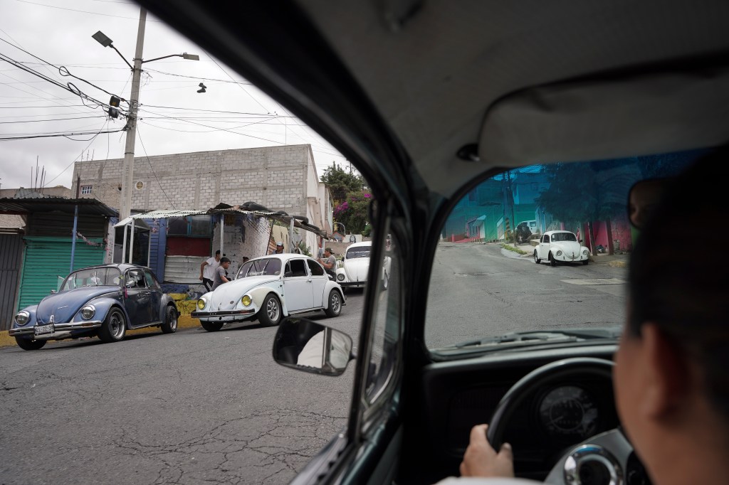 Taxi driver Janette Navarro steers her 1996 Volkswagen Beetle up a steep hill