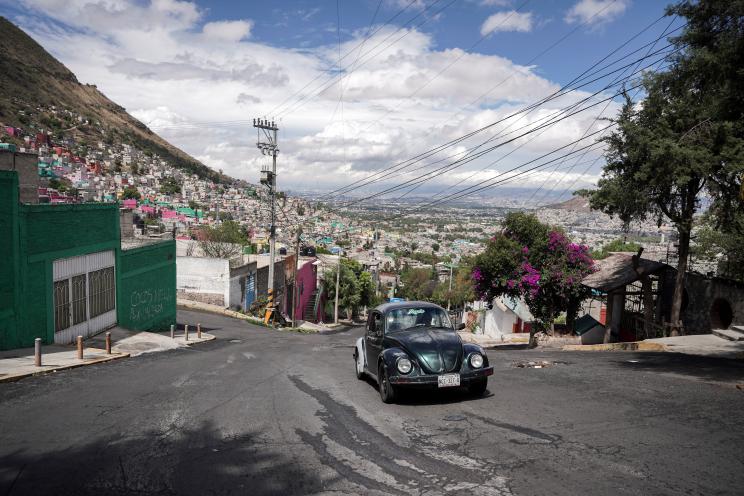 Janette Navarro drives her 1996 Volkswagen Beetle up a steep hill